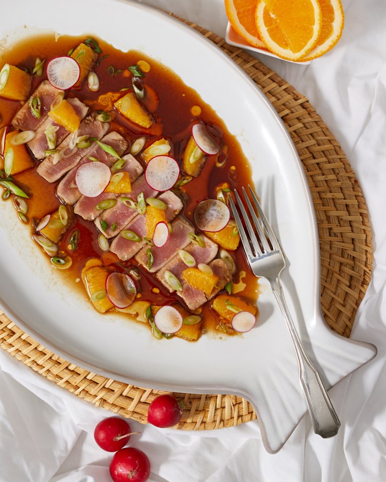 A beautifully plated dish featuring seared tuna with garnishes of orange segments, radishes, green onions, and a flavorful sauce, served on a decorative fish-shaped platter.
Private Chef Collingwood, Private Chef Toronto
